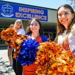  Athen's Drive High School students celebrating outside of the school with pom poms 